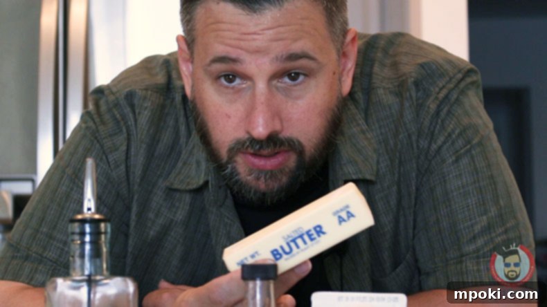 Dads Guide To Flawless French Toast 3 Dad's hand holding a stick of butter, hinting at the traditional but less effective method.