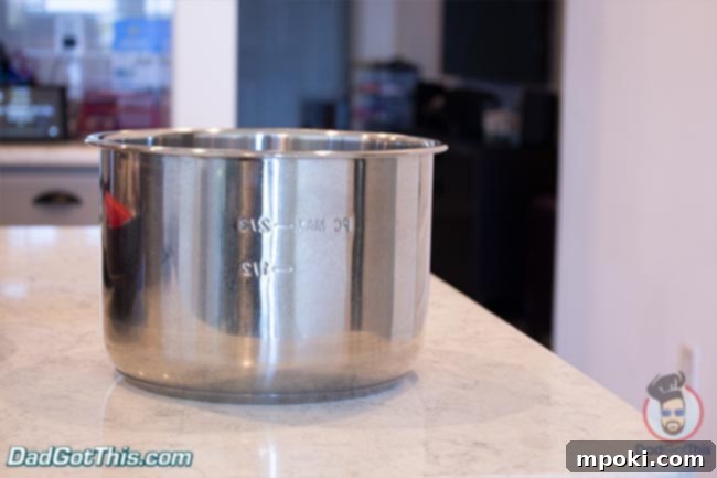 The stainless steel inner pot of an Instant Pot, where food is placed for cooking.