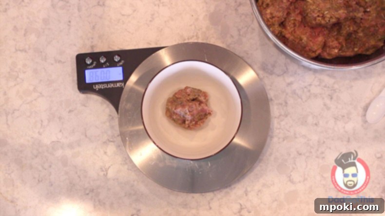 Authentic Italian Meatballs from Scratch 4 A kitchen scale precisely weighing a portion of meatball mixture, emphasizing the importance of uniform sizing for homemade meatballs.