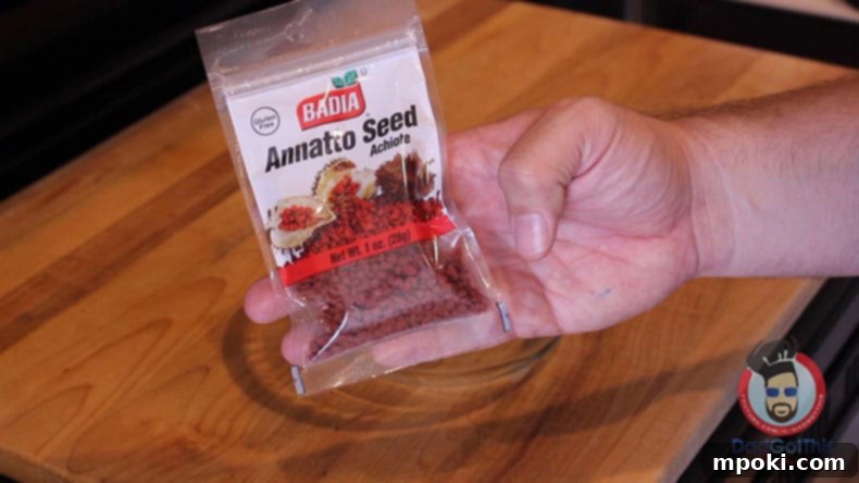 Effortless Instant Pot Kare Kare Filipino Classic Made Simple 4 a hand holding a bag of annatto seeds