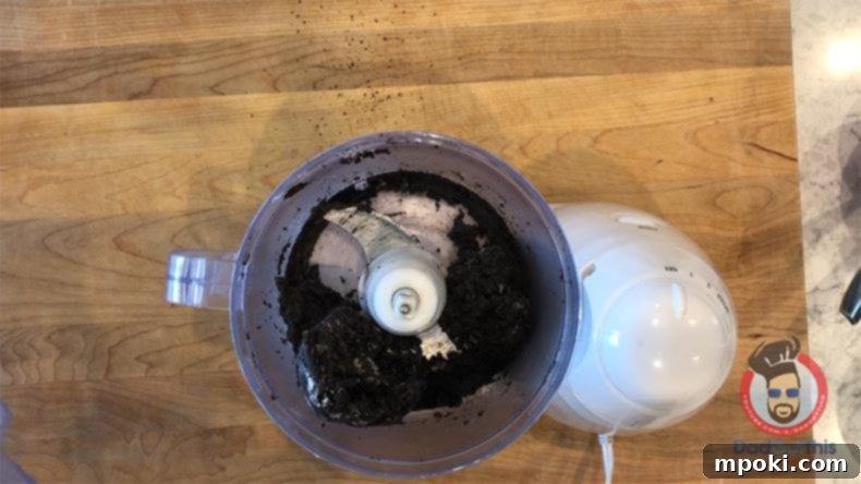 Spooktacular Oreo Truffles: Easy, Cheap, and Delicious 5 Oreo truffle dough forming in a food processor after cream cheese has been added.