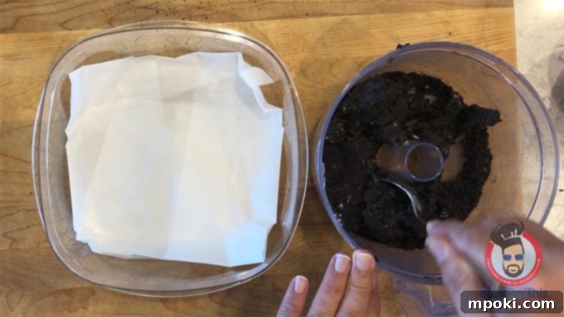 Spooktacular Oreo Truffles: Easy, Cheap, and Delicious 6 A container lined with wax paper, ready for rolling Oreo truffle dough, next to a food processor bowl.
