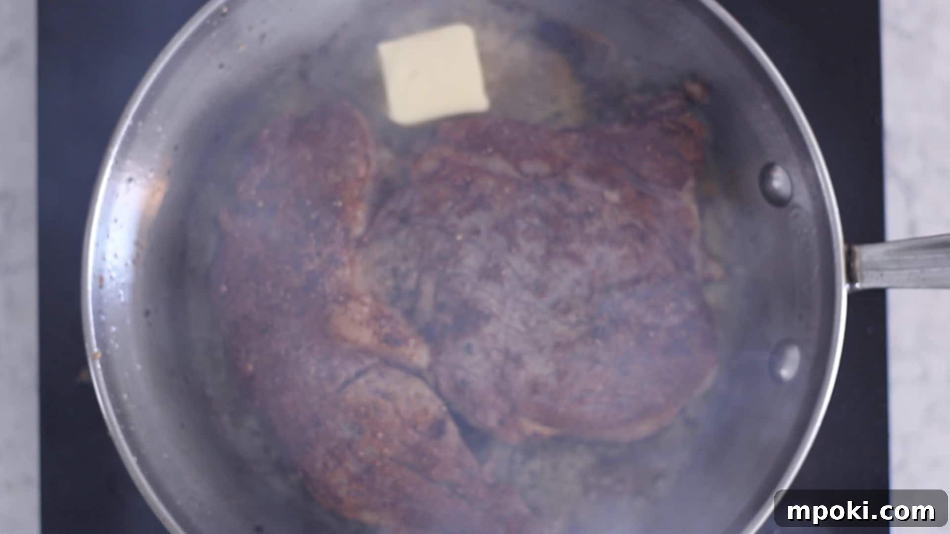 Unlocking Steak Perfection with Reverse Sear 7 A freshly reverse seared steak resting on a wooden cutting board, allowing its juices to redistribute for maximum tenderness.