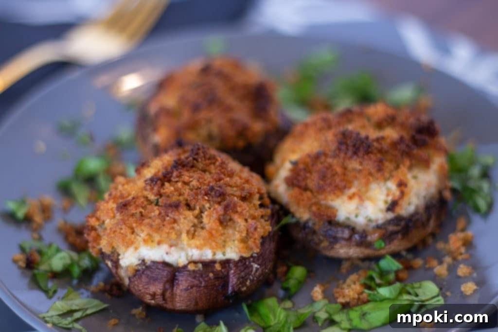 Crab-Stuffed Mushrooms: Air Fryer and Oven Delights 2 3 seafood stuffed mushrooms on a grey plate