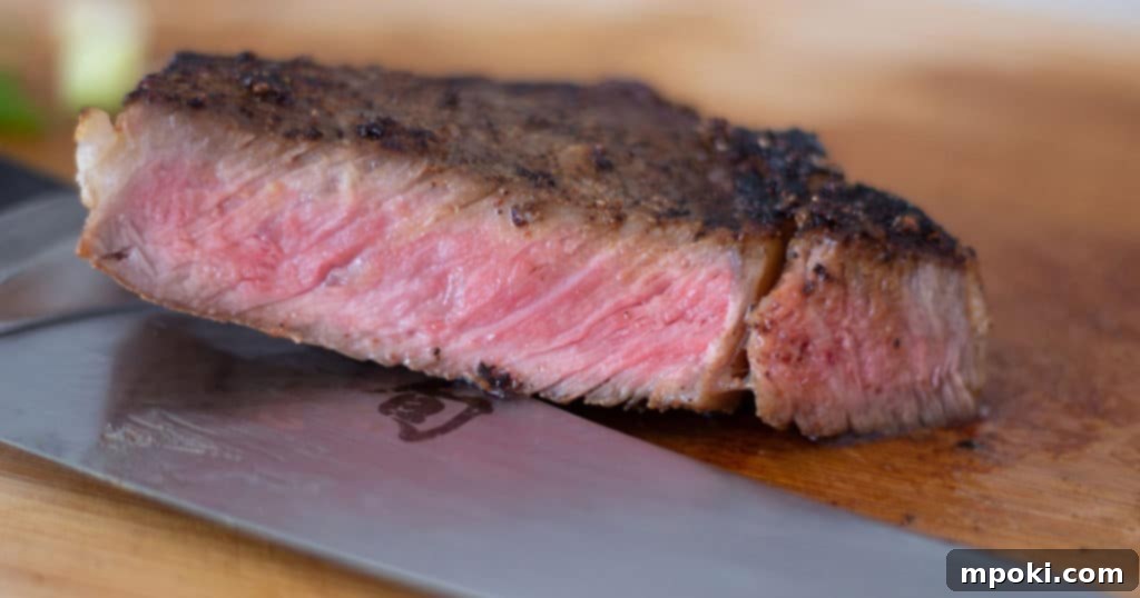 Crab-Stuffed Mushrooms: Air Fryer and Oven Delights 16 A reverse seared steak cut on a cutting board with a knife