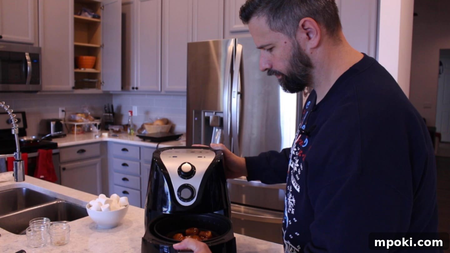 Air Fryer Candied Yams and Toasted Marshmallows 6 Candied yams cooking in an air fryer basket at 350 degrees Fahrenheit