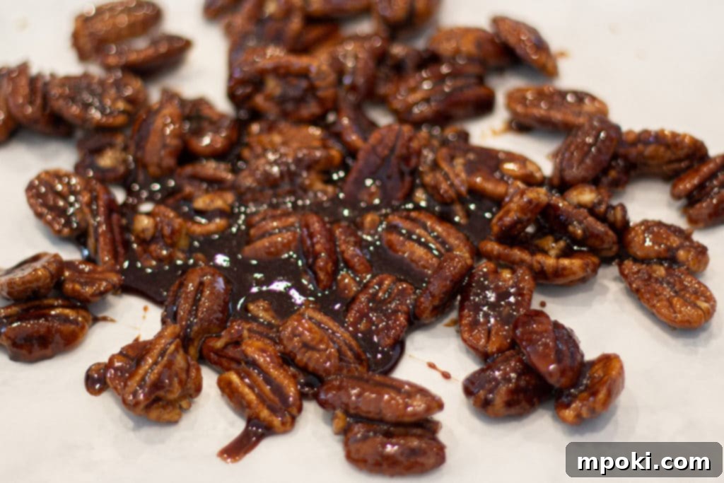 Delicious 5 Minute Candied Pecans 2 Delicious Candied Pecans cooling on parchment paper, ready to be enjoyed