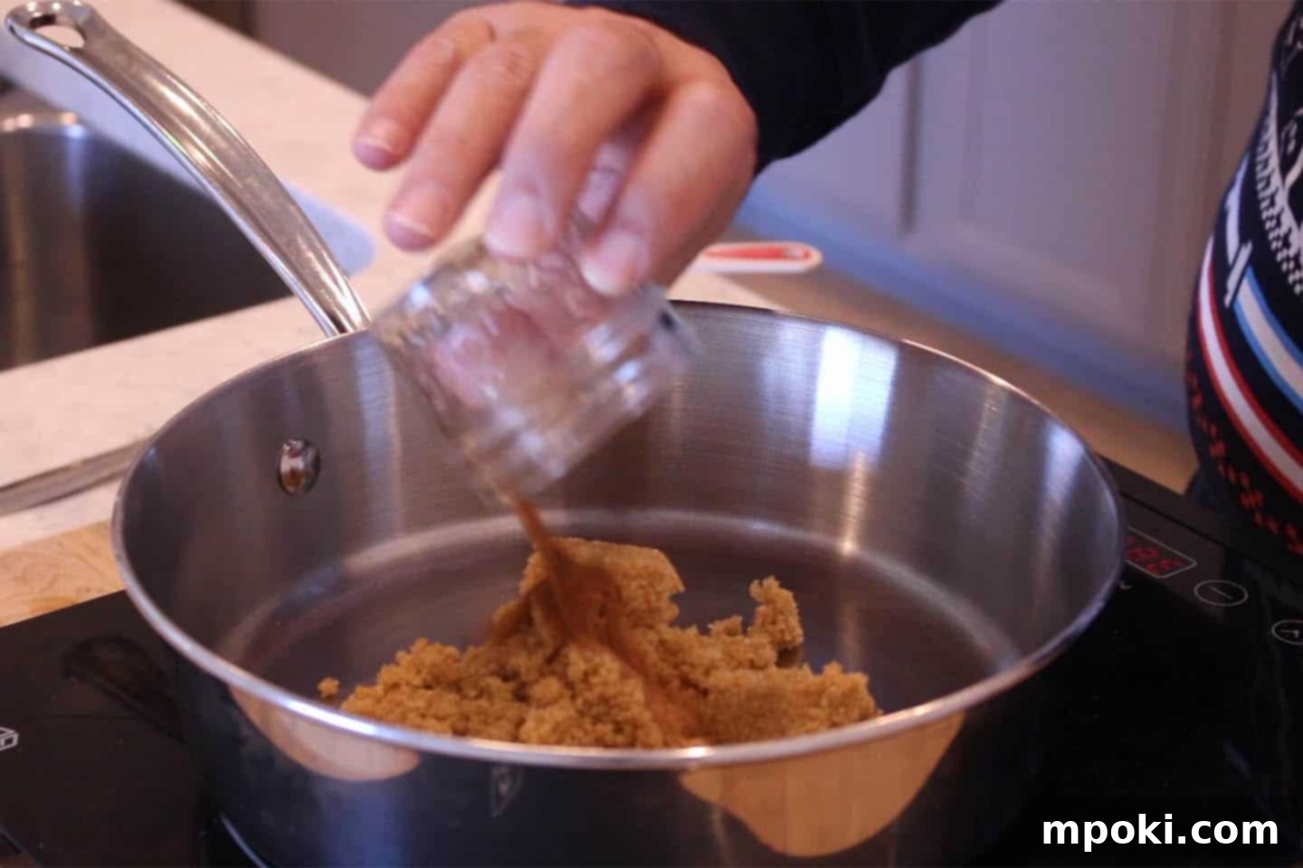 Delicious 5 Minute Candied Pecans 3 Pan with brown sugar and spices over medium heat