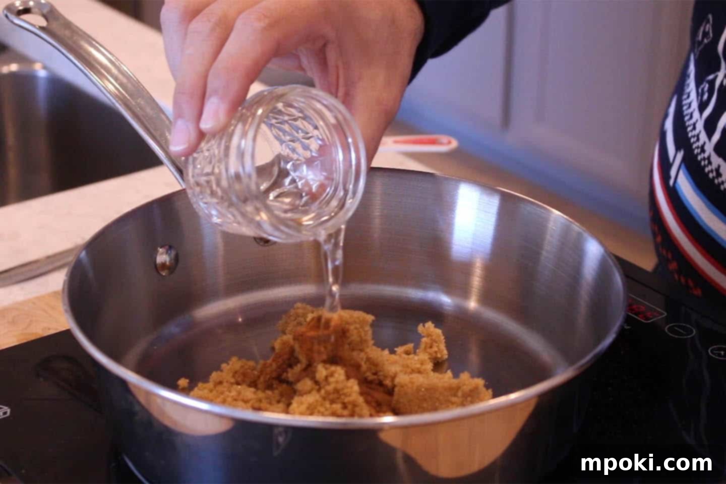 Delicious 5 Minute Candied Pecans 4 Water being poured into the brown sugar and spice mixture