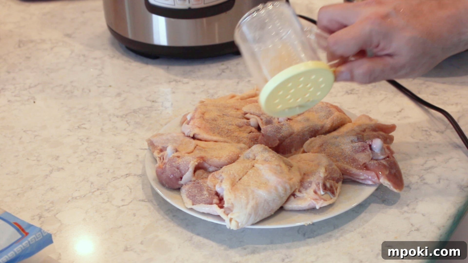 One-Pot Instant Pot Pancit Bihon 4 chicken thighs being seasoned for pancit