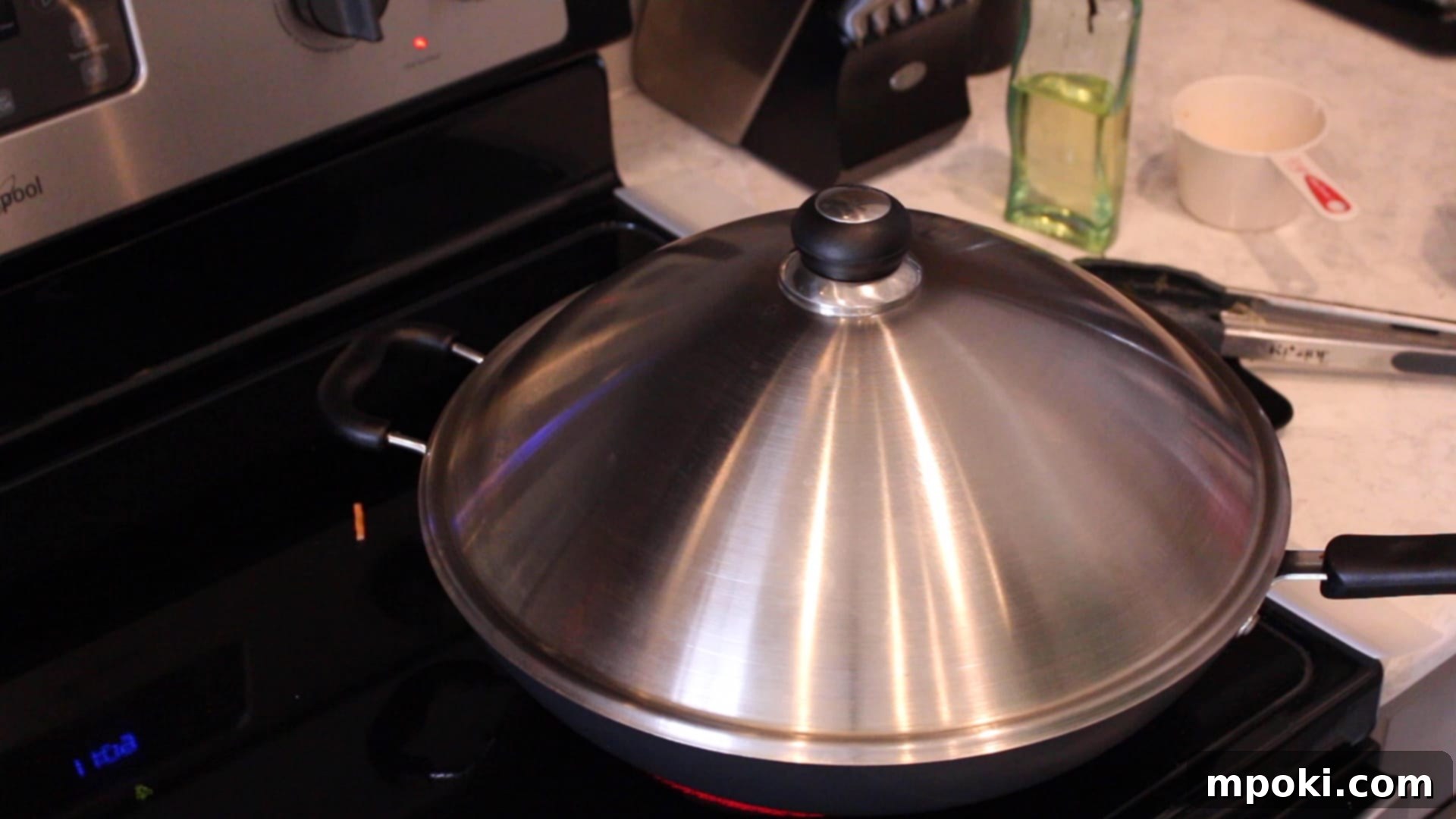 One-Pot Instant Pot Pancit Bihon 9 A wok with a lid on a stove.