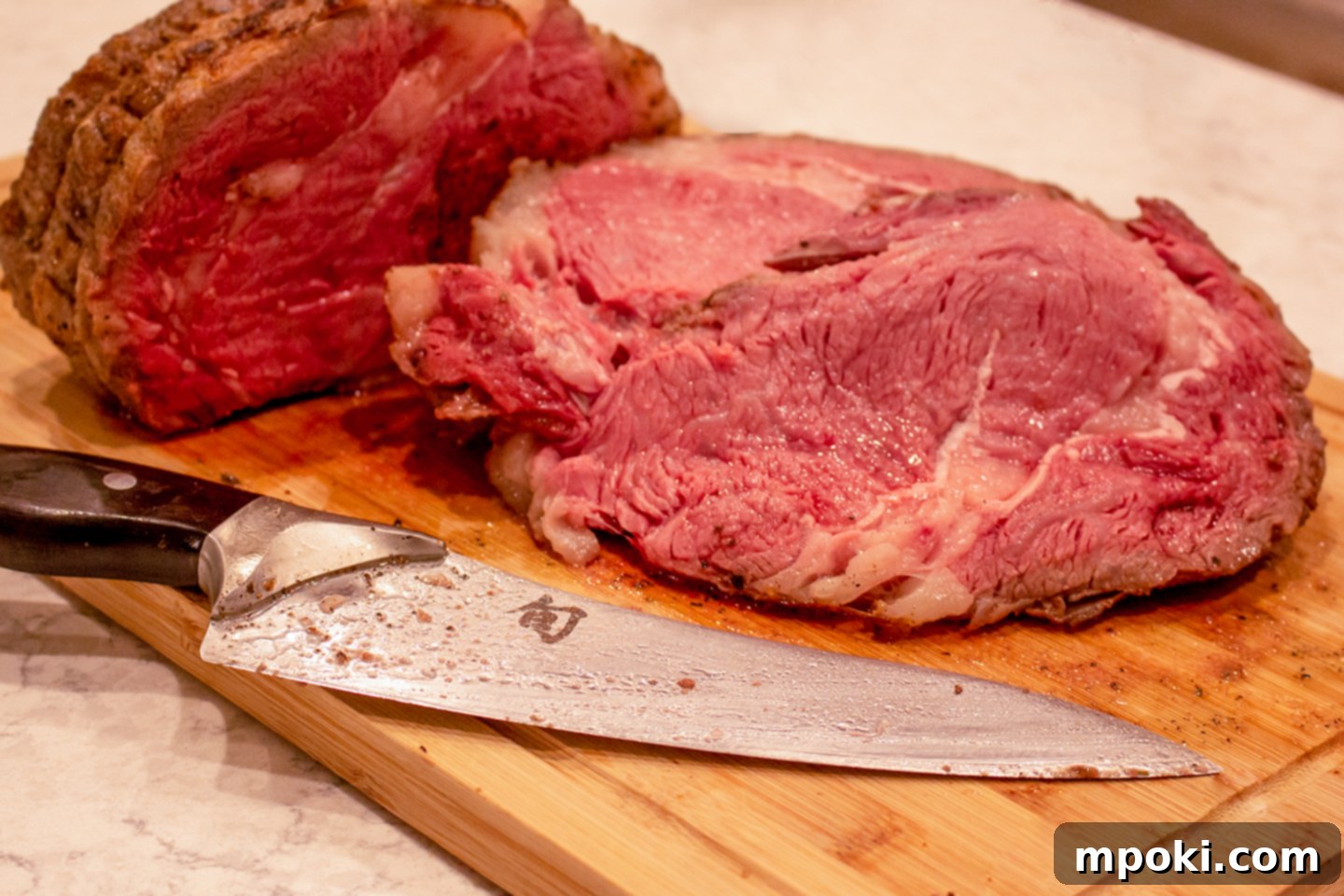 Perfect Sous Vide Prime Rib 2 Perfectly cooked sous vide prime rib on a cutting board, ready for slicing