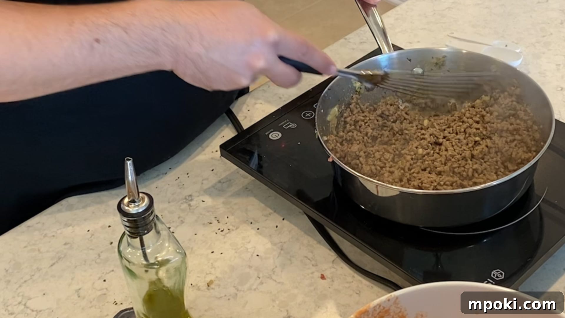 Effortless Homemade Meat Sauce 7 Ground beef and pork mixture browning in a pan with spices