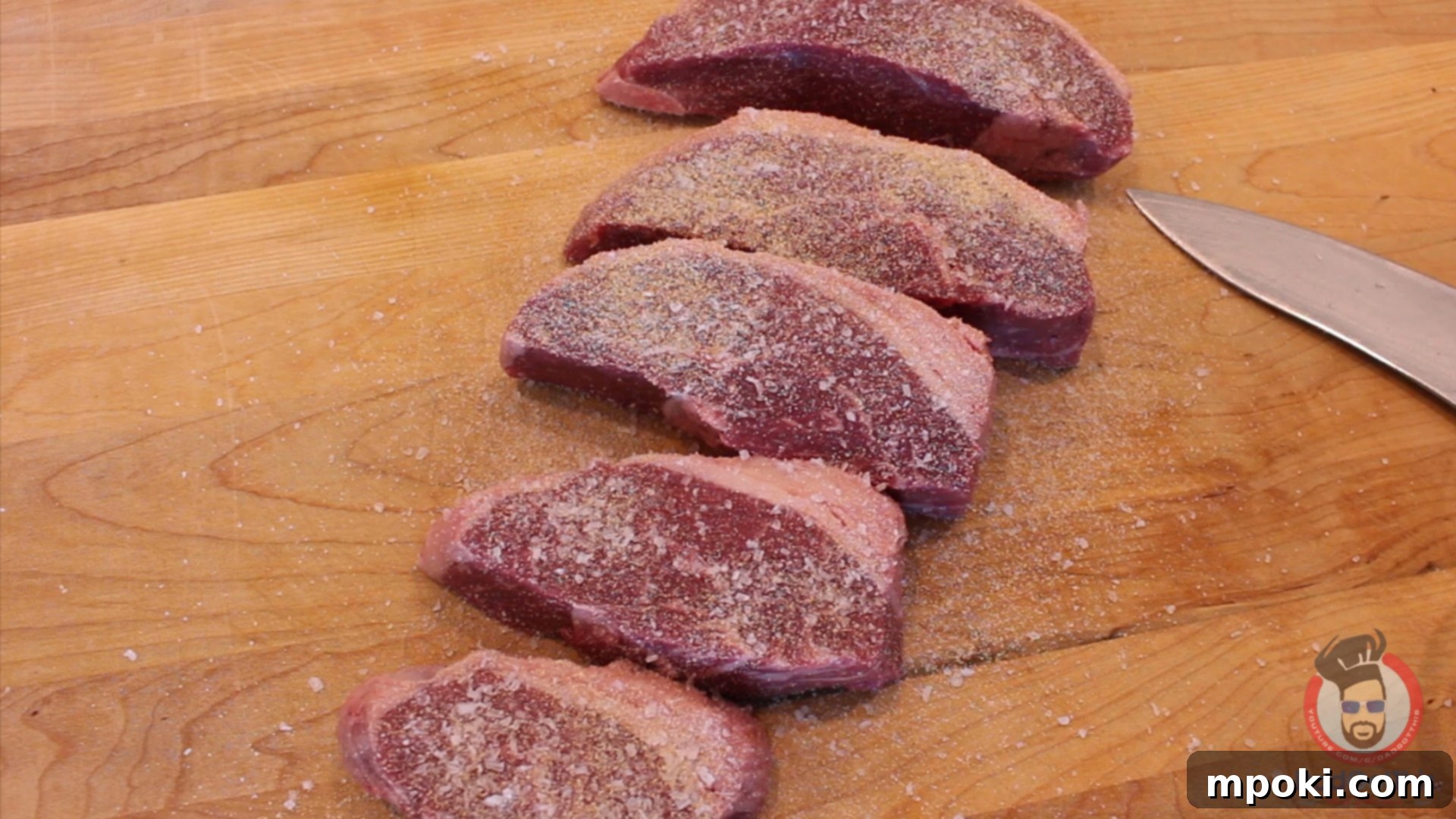Charcoal Kissed Sous Vide Picanha 4 seasoned picanha steaks liberally covered with spices on a cutting board