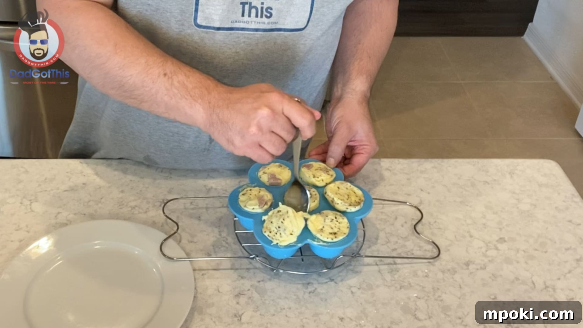 Perfect Instant Pot Egg Bites 6 Releasing perfectly cooked egg bites from the silicone mold using a spoon