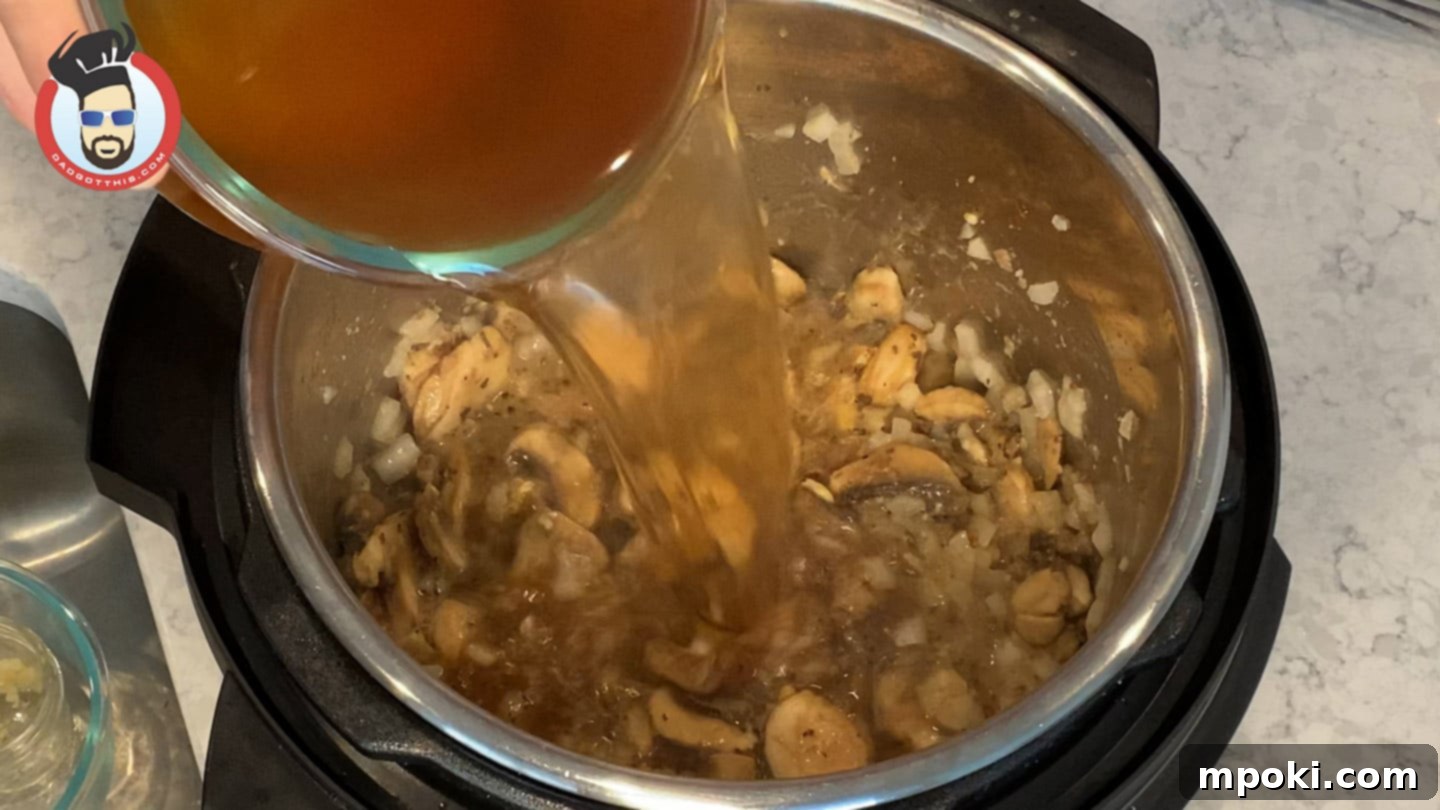 Quick and Creamy Instant Pot Beef Stroganoff 7 Adding beef broth and Worcestershire sauce to the Instant Pot before pressure cooking.