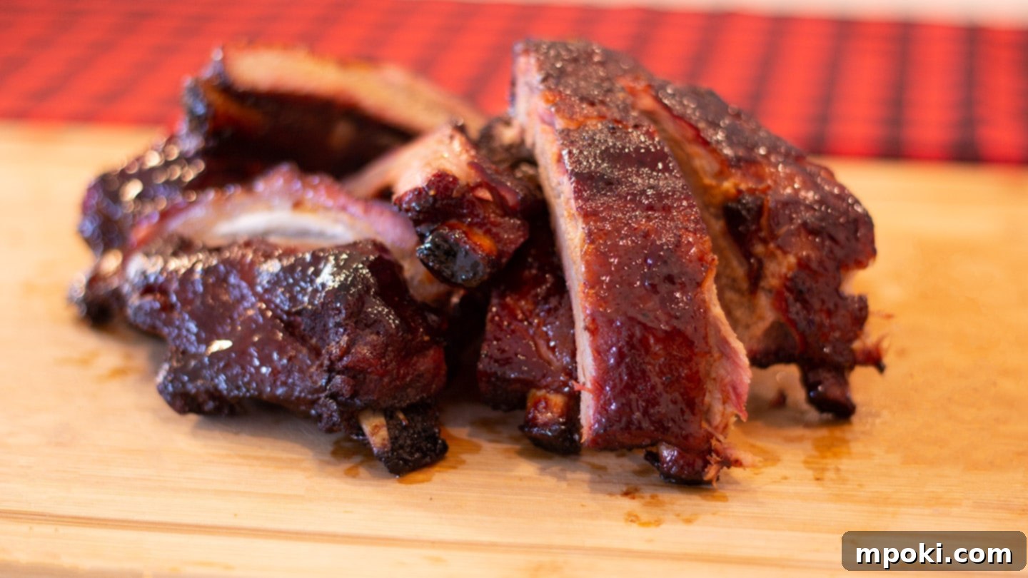 Slow Smoked Weber Kettle Ribs 2 Delicious BBQ Ribs on a cutting board, ready to be served