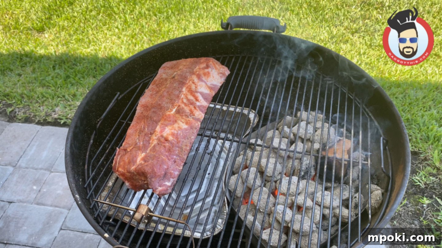 Slow Smoked Weber Kettle Ribs 4 Indirect grilling setup on a Weber Kettle with charcoal on one side and a water pan on the other