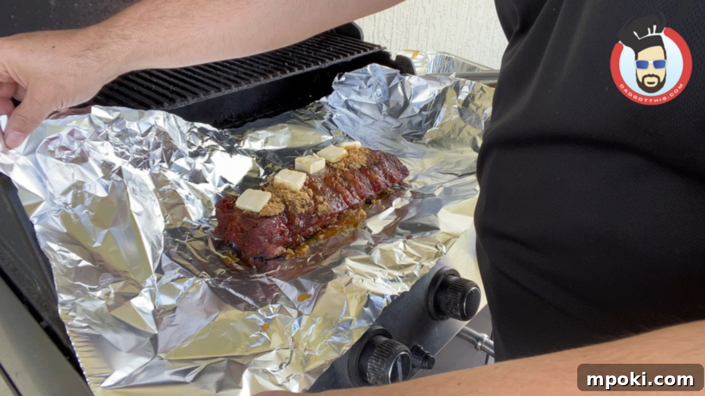 Slow Smoked Weber Kettle Ribs 5 Wrapping ribs in aluminum foil with butter, brown sugar, and honey