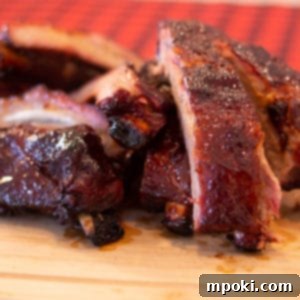 Slow Smoked Weber Kettle Ribs 8 Delicious Weber Kettle Smoked Ribs on a cutting board