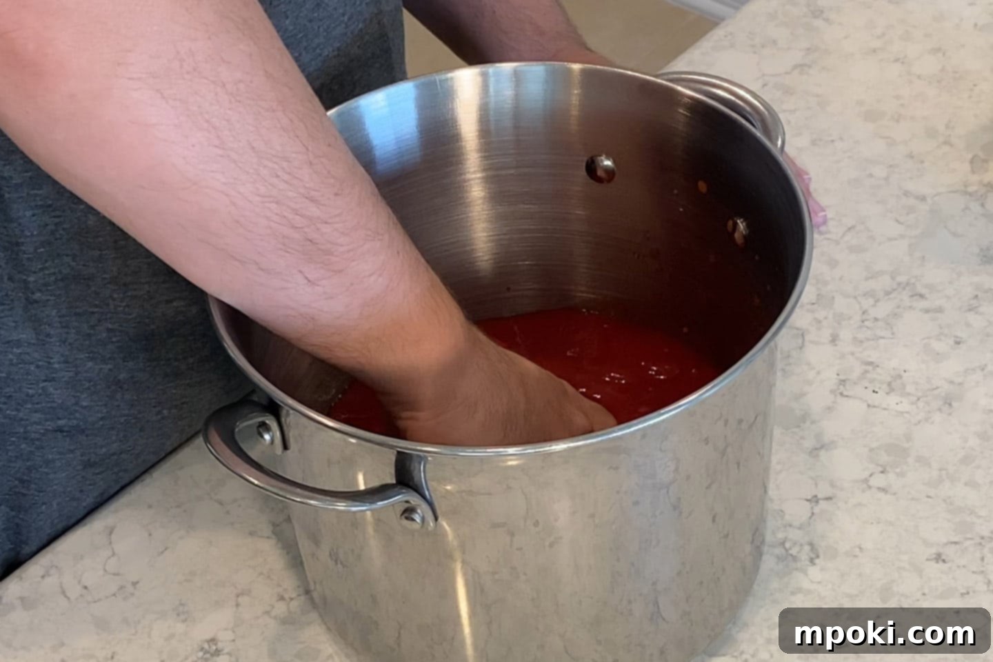 Grandma's Secret Sunday Sauce 3 crushing the tomatoes