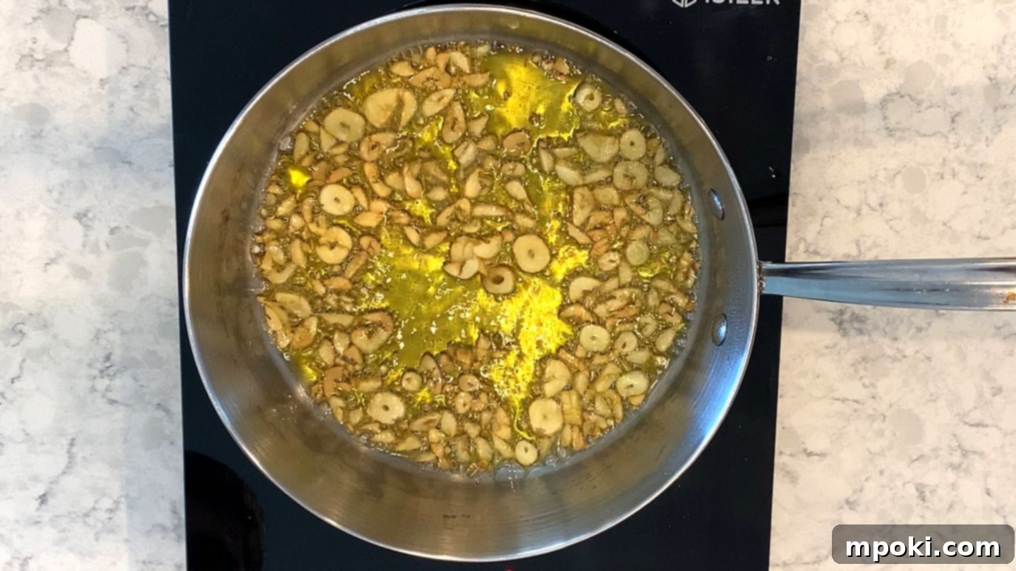 Sizzling Garlic Chili Pasta 4 Garlic beginning to brown in olive oil in a pan
