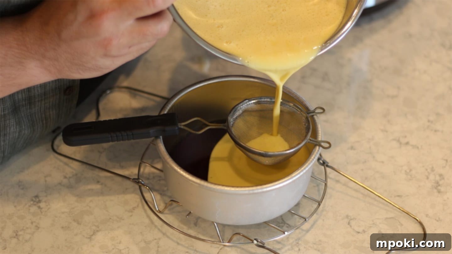 Authentic Leche Flan Quick Instant Pot Recipe 7 Pouring the creamy Leche Flan custard mixture through a fine-mesh strainer into the caramel-coated cake pan to ensure a smooth, bubble-free texture.