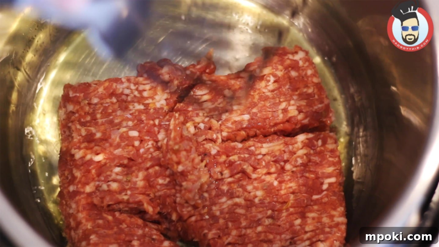 Hearty Instant Pot Zuppa Toscana 5 Crumbled Italian sausage, garlic powder, and onion powder sizzling and browning in the bottom of an Instant Pot, building the flavor base for Zuppa Toscana.