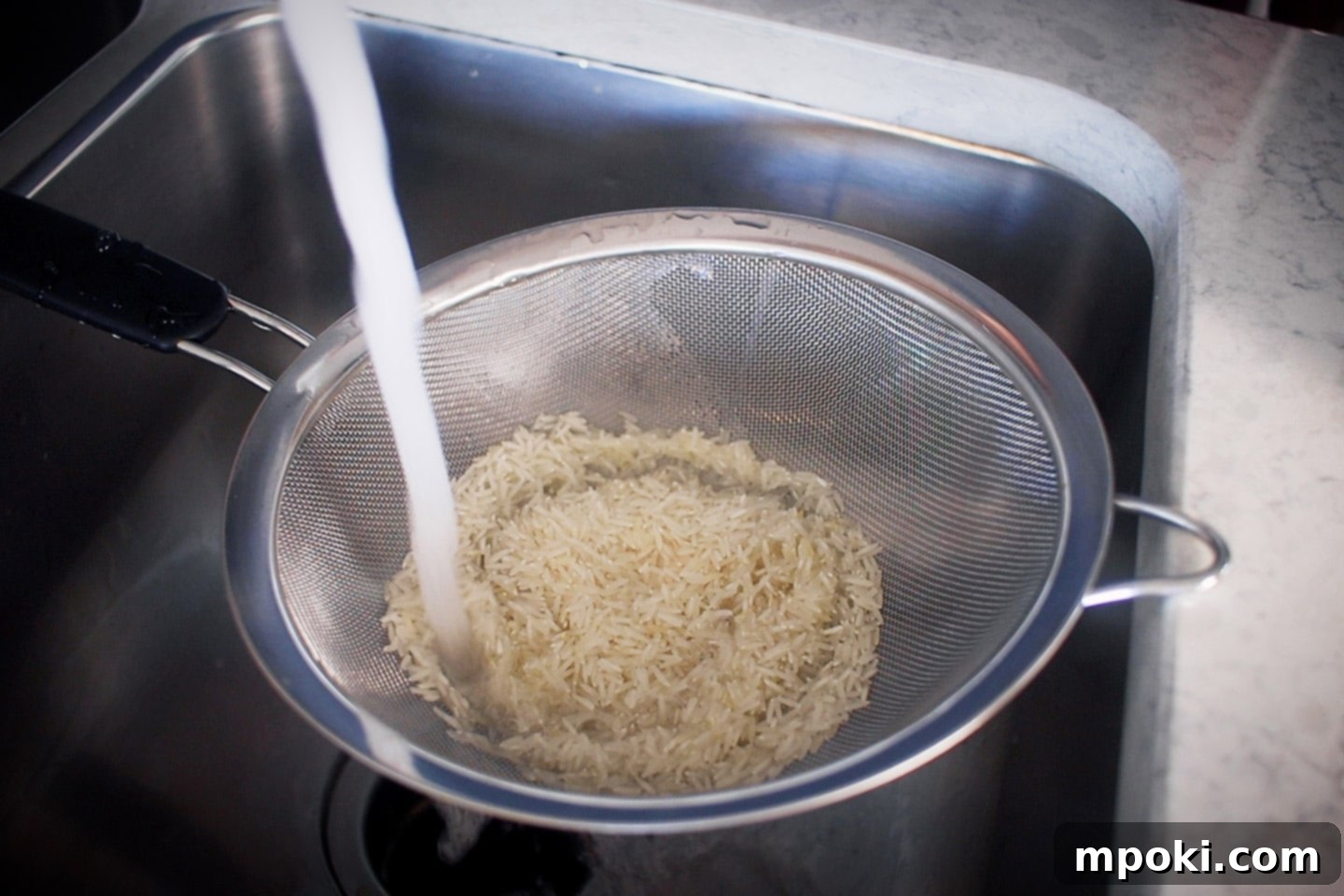 Unlock Perfect Basmati Rice with Your Instant Pot 3 Rising basmati rice in a strainer
