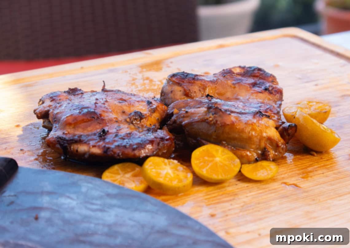 Ninja Woodfire Smoked Filipino BBQ Chicken Thighs 2 ninja woodfire chicken thighs on a cutting board