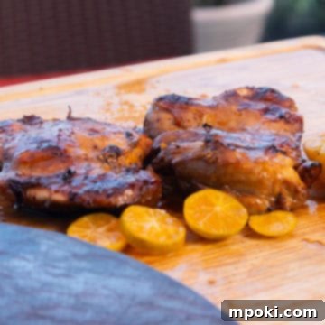 Ninja Woodfire Smoked Filipino BBQ Chicken Thighs 3 Filipino Style BBQ Smoked Chicken Thighs on a cutting board