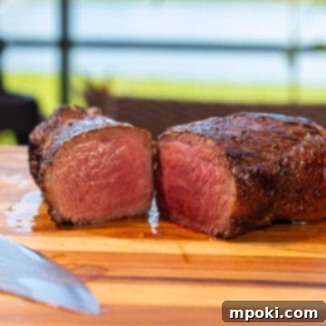 Ultimate Ninja Woodfire Smoked Picanha 3 Smoked Picanha Steak on a cutting board with Ninja Woodfire in the background.