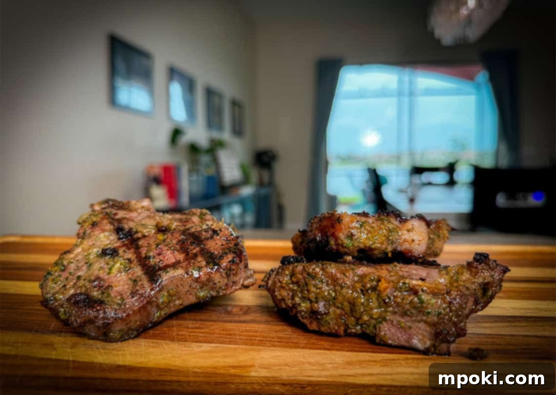 Flame-Grilled Mediterranean Lamb Chops 2 Perfectly grilled lamb chops, golden brown and juicy, resting on a wooden cutting board with fresh herbs. The bones are visible, hinting at the rich flavor.