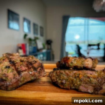 Flame-Grilled Mediterranean Lamb Chops 3 Grilled Lamb Chops on a cutting board.