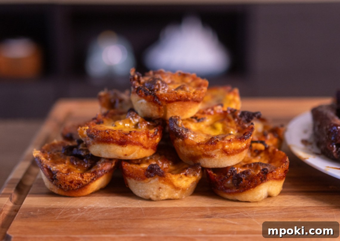 Smoked Philly Cheesesteak Pizza Poppers 2 Irresistible Woodfire Philly Cheesesteak Pizza Cups, golden brown and filled with savory goodness, perfect for any gathering.
