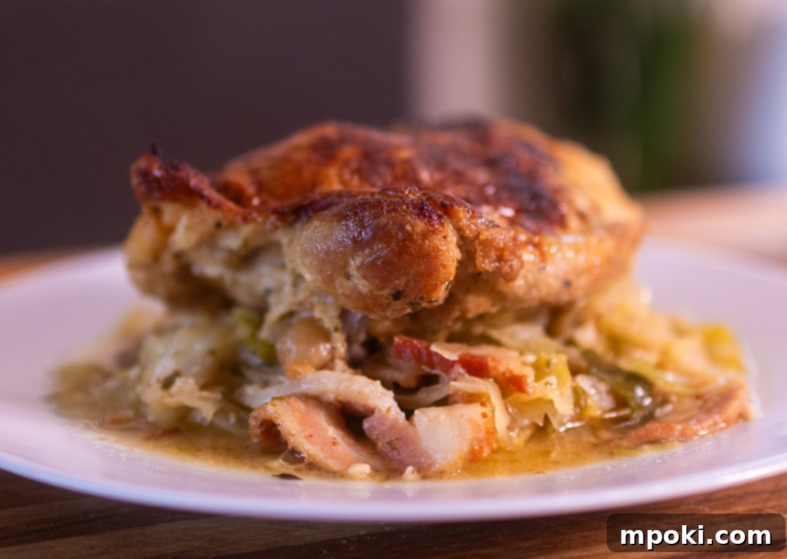 Wood-Fired Chicken with Golden Crispy Skin and Savory Braised Bacon Cabbage 2 Smoky Woodfire Chicken Thighs with Crispy Skin and Braised Cabbage and Bacon