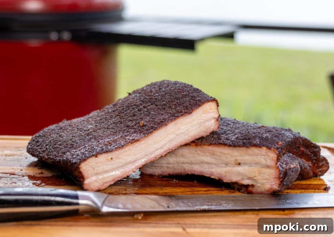 Kamado Joe's Melt-in-Your-Mouth Smoked Pork Belly 2 Kamado Joe BBQ Smoked Pork Belly with a perfect bark, ready to be sliced.