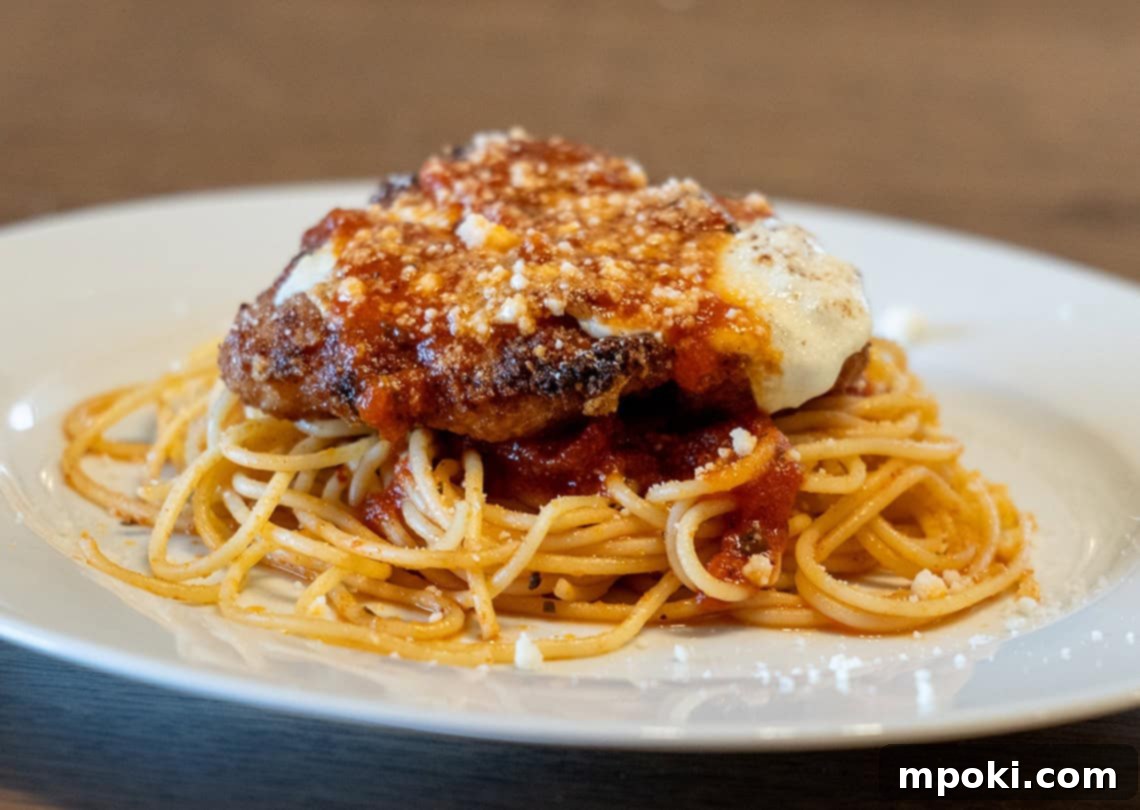 Crispy Cast Iron Chicken Parmesan 2 Crispy Cast Iron Chicken Parmesan with bubbling cheese and rich red sauce