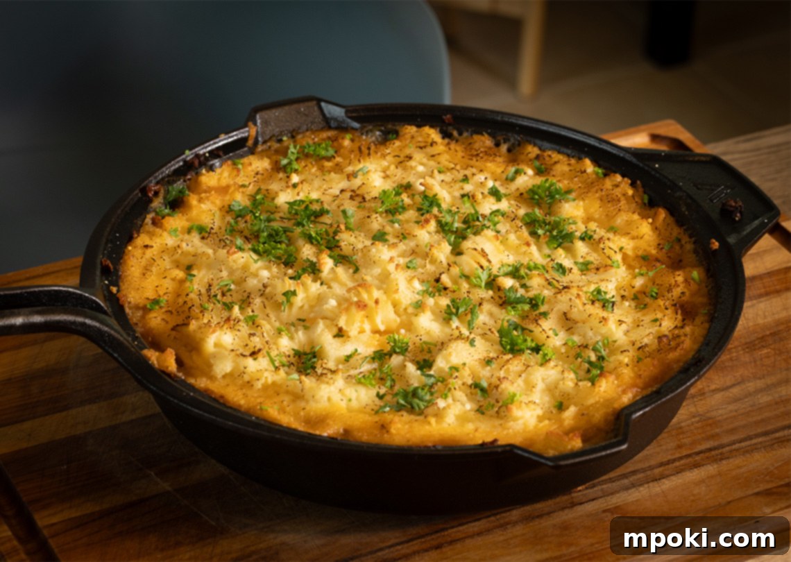 Hearty Cast Iron Shepherd's Bake 2 Cast Iron Shepherds Pie: A hearty meat and vegetable base topped with golden mashed potatoes, baked in a cast iron skillet.