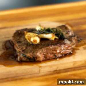 Cast Iron Seared Bavette 3 Bavette Steak in a cast iron pan with herbs and garlic.